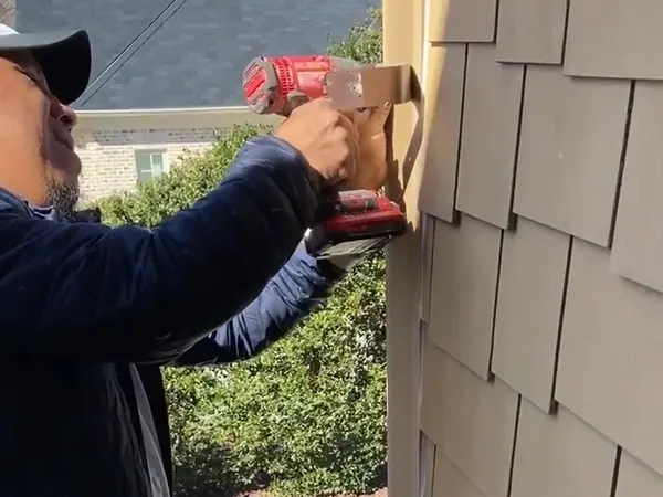 ADA Design and Build installing shake-style siding on a gable wall